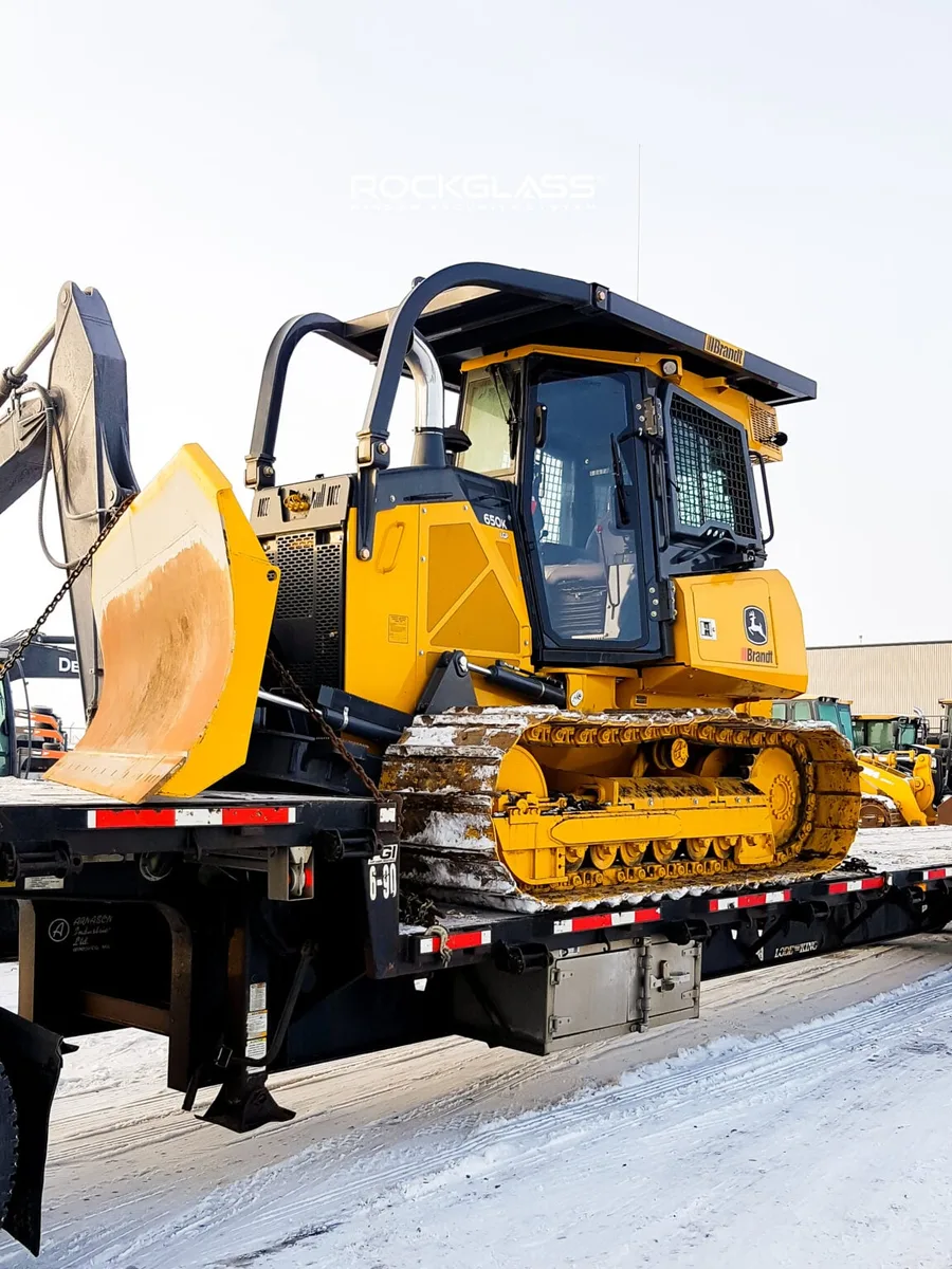 Industrial loader cab protected with impact-resistant security glass