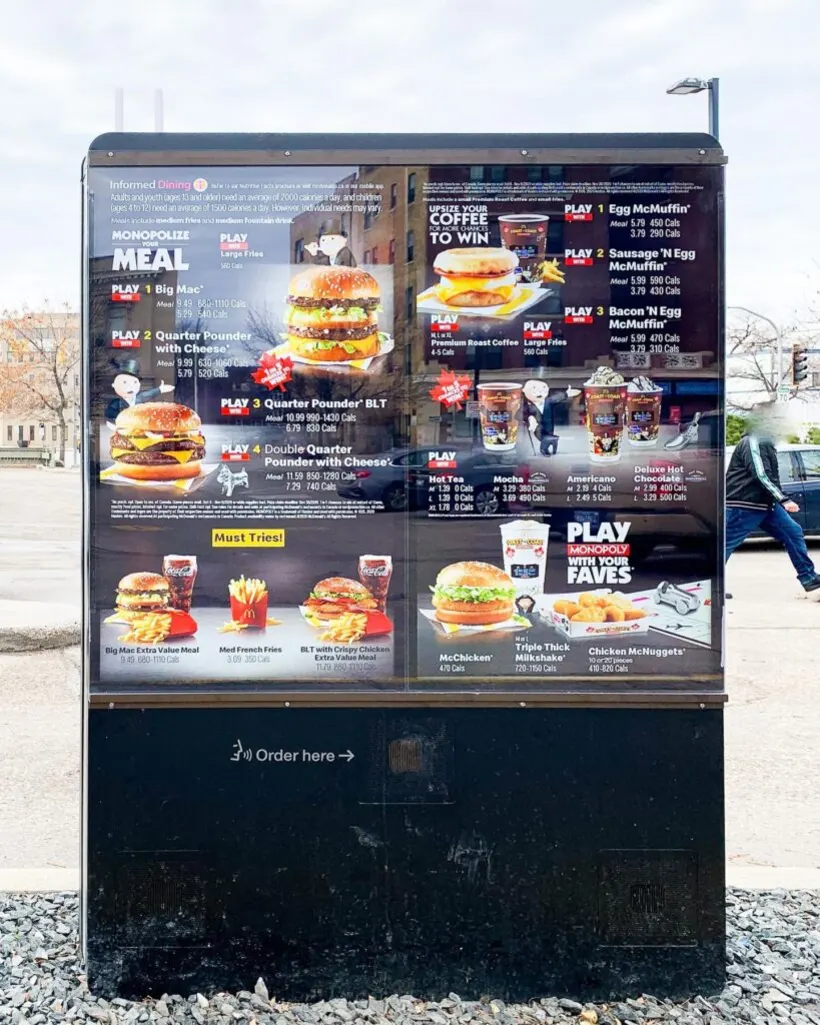 Outdoor drive-thru menu board with RockGlass screen protection installed over the digital displays